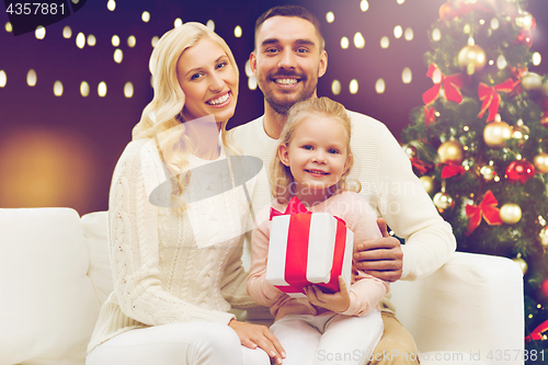 Image of happy family with christmas gift