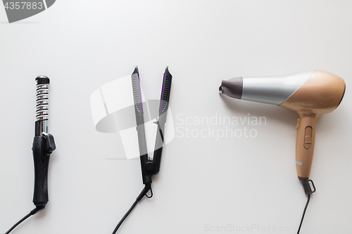 Image of hairdryer, hot styler and curling iron or tongs