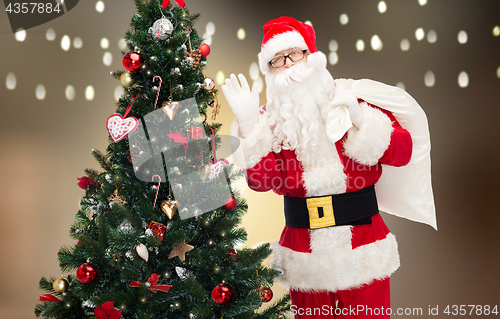 Image of santa claus with bag and christmas tree