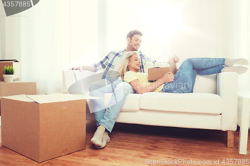 Image of happy couple with big cardboard boxes at new home