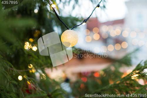 Image of close up of christmas tree garland bulb outdoors