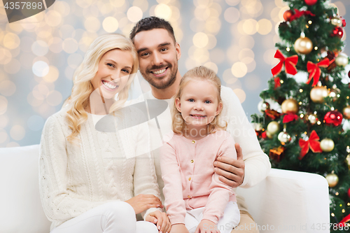 Image of happy family over christmas tree