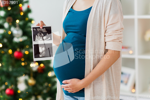 Image of pregnant woman with ultrasound images at christmas