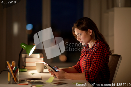 Image of student girl or woman with tablet pc at night home