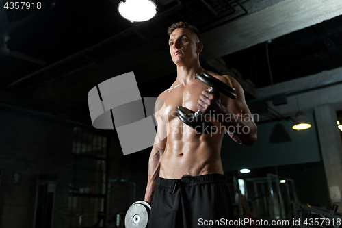 Image of close up of man with dumbbells exercising in gym