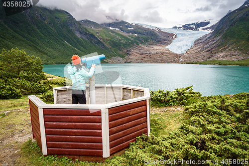 Image of Svartisen Glacier in Norway. Tourist girl looking Glacier.