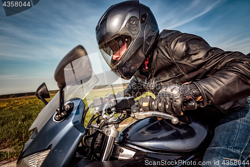 Image of Biker racing on the road