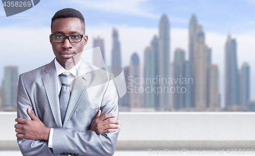 Image of Young black businessman in front of the big city