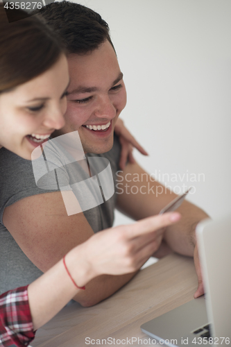 Image of happy young couple buying online