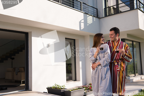 Image of Young beautiful couple in bathrobes