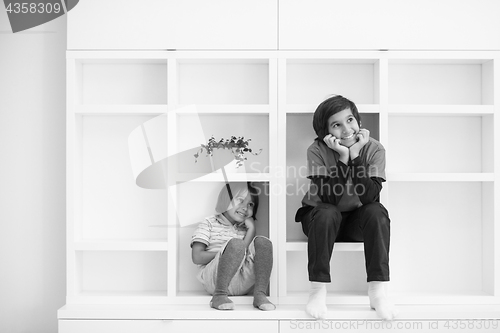 Image of young boys posing on a shelf