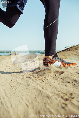 Image of Running sport. Man runner sprinting outdoor in scenic nature. Fit muscular male athlete training trail running for marathon run.