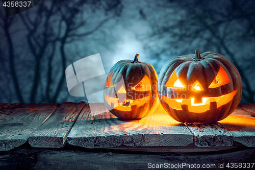 Image of Halloween pumpkins on blue background