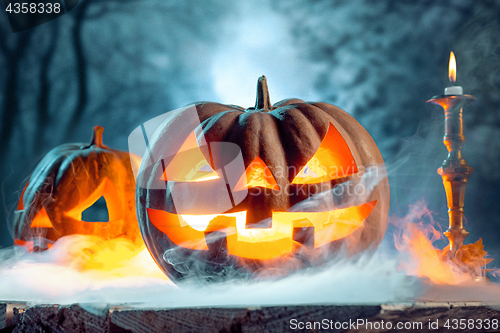 Image of Halloween pumpkins on blue background