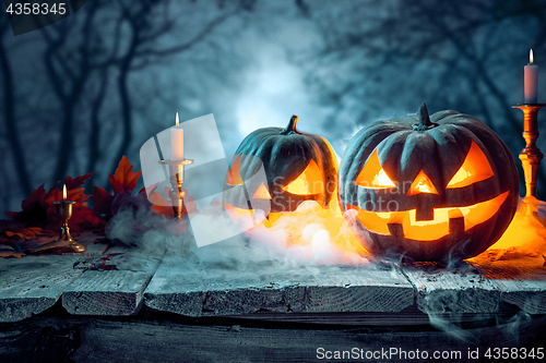 Image of Halloween pumpkins on blue background