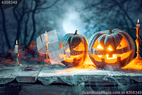 Image of Halloween pumpkins on blue background