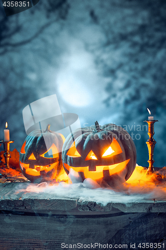 Image of Halloween pumpkins on blue background