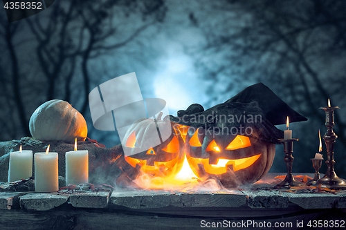 Image of Halloween pumpkins on blue background