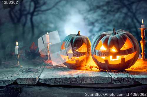 Image of Halloween pumpkins on blue background