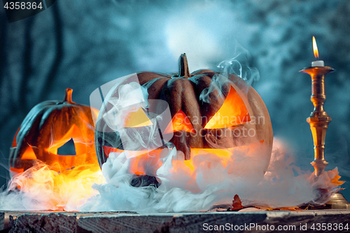 Image of Halloween pumpkins on blue background