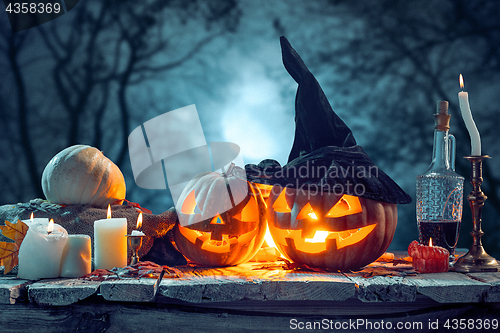 Image of Halloween pumpkins on blue background