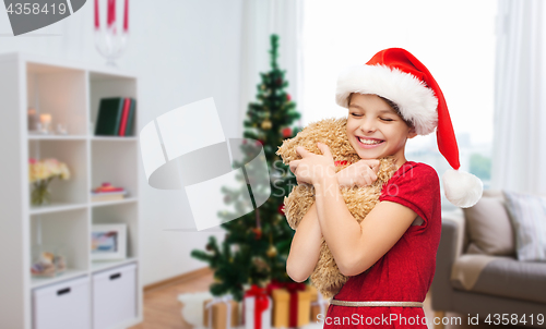 Image of happy girl with teddy bear at christmas