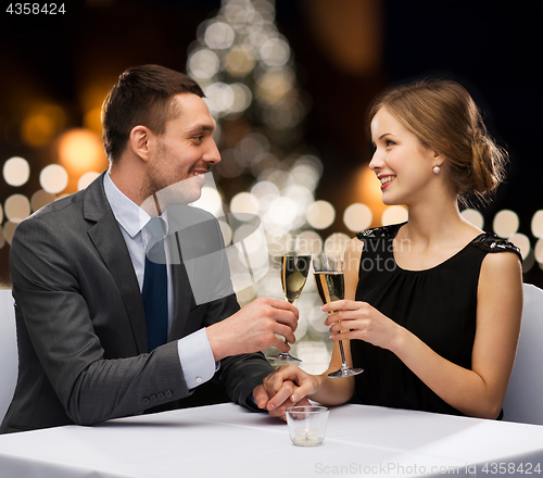 Image of couple with non alcoholic champagne at christmas