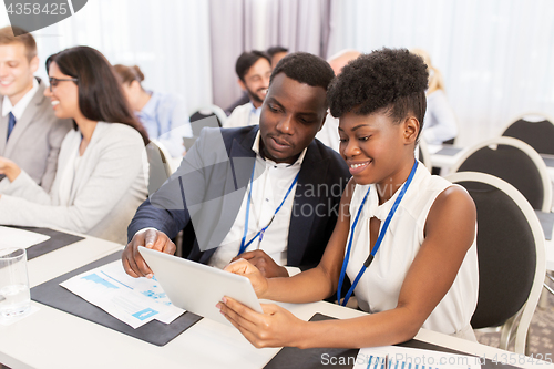 Image of team with tablet pc at business conference