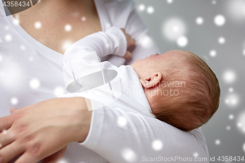 Image of close up of mother holding newborn baby