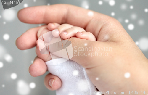 Image of close up of mother and newborn baby hands