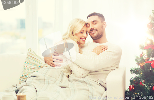 Image of happy couple at home with christmas tree