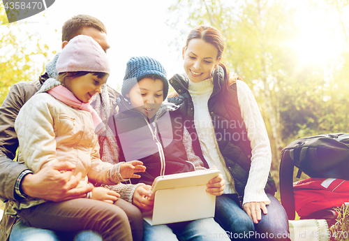 Image of happy family with tablet pc and backpacks at camp