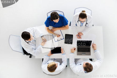 Image of doctors with cardiogram and computers at hospital