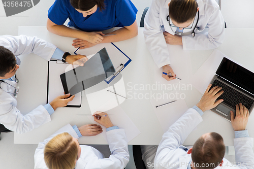 Image of group of doctors with x-ray and laptop at clinic