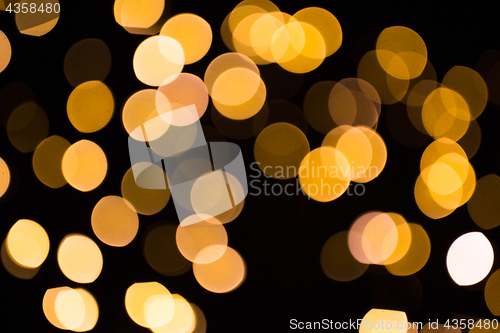 Image of blurred golden lights over dark background