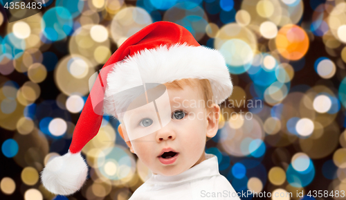 Image of little baby boy in santa hat at christmas