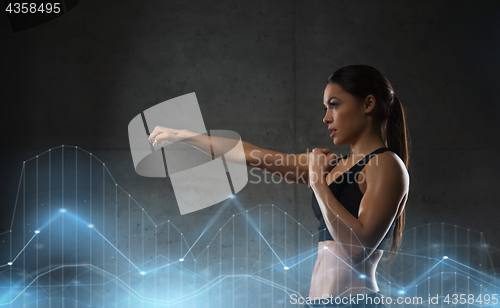 Image of woman boxing in gym