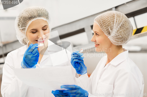 Image of women technologists tasting ice cream at factory