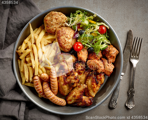 Image of plate of various meats and vegetables