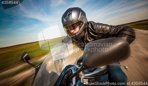 Image of Biker racing on the road