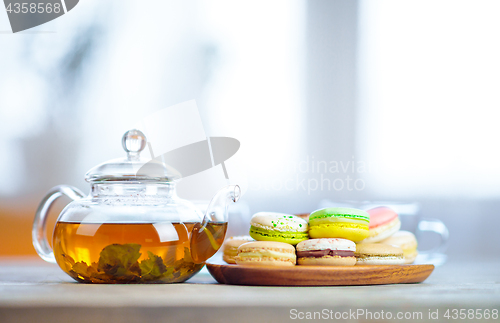 Image of Close-up of colorful macaron (macaroon) on the table with hot te