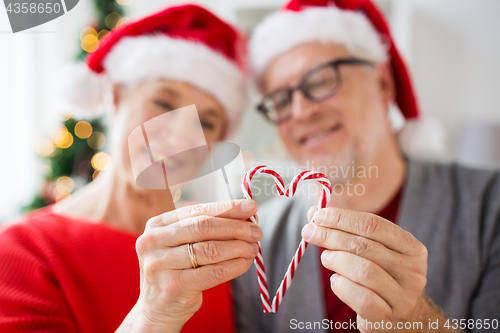 Image of senior couple with heart of christmas candy canes