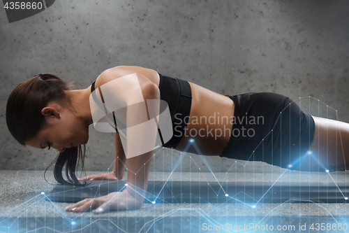 Image of woman doing push-ups in gym