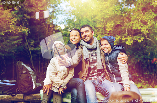 Image of happy family with backpacks hiking