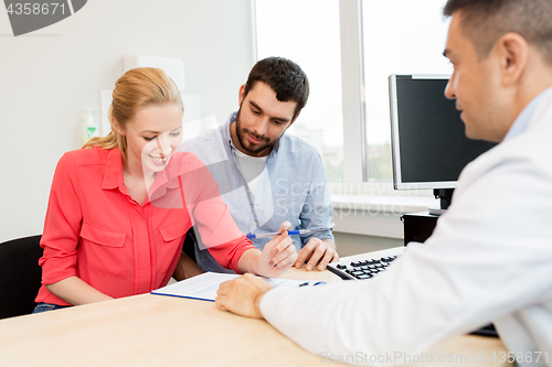 Image of couple visiting doctor at family planning clinic