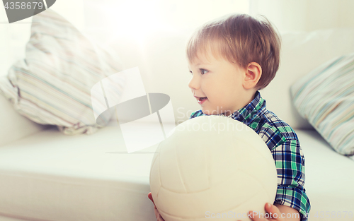 Image of happy little baby boy with ball at home