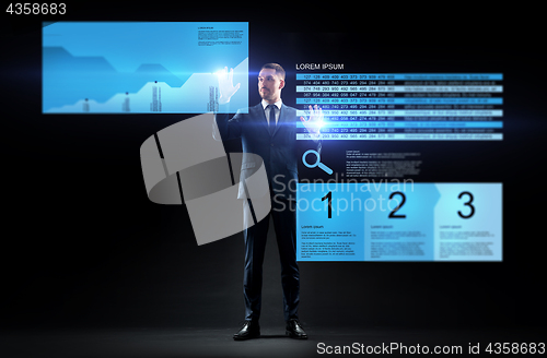 Image of businessman with stock charts on virtual screens