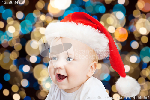 Image of little baby boy in santa hat at christmas