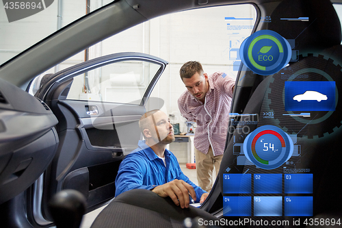 Image of auto mechanic and man at car shop