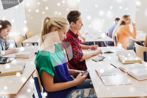 Image of student girl with smartphone texting at school